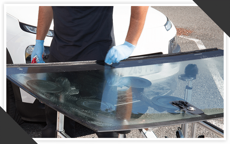 image of a man fixing a windshield